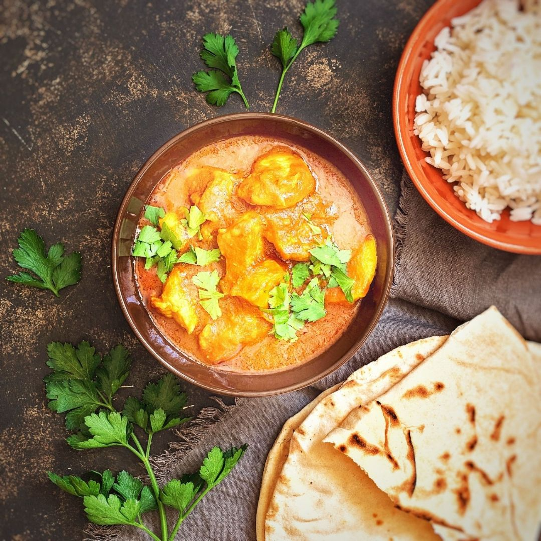 Prepared Chicken tikka masala with rice and naan