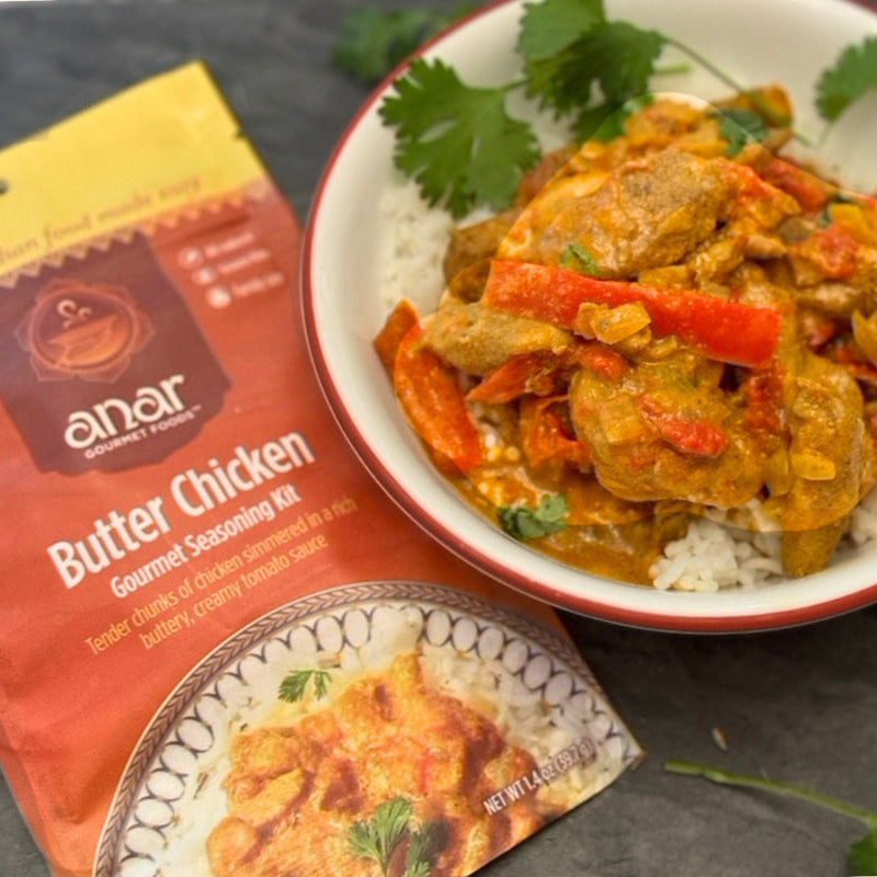 Butter Chicken with bell peppers over rice, made with Anar Gourmet Foods all natural, gluten-free seasoning