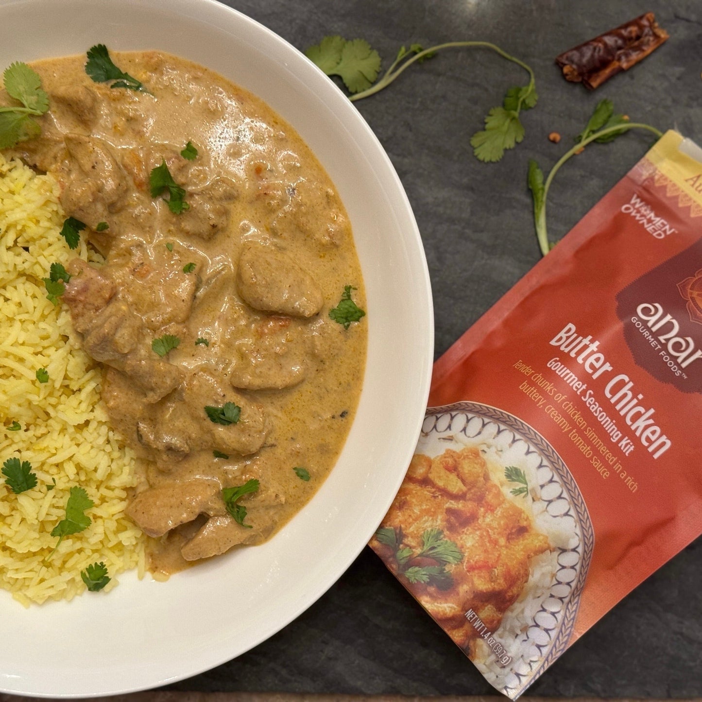 Bowl of Butter Chicken with coconut rice, made with Anar Gourmet Foods all natural, gluten-free seasoning