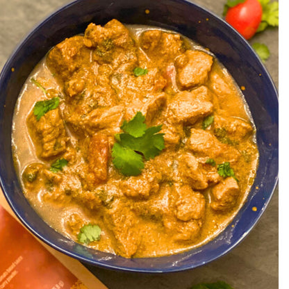 Anar Gourmet Foods all-natural, gluten-free lamb curry seasoning — close-up of lamb curry garnished with cilantro