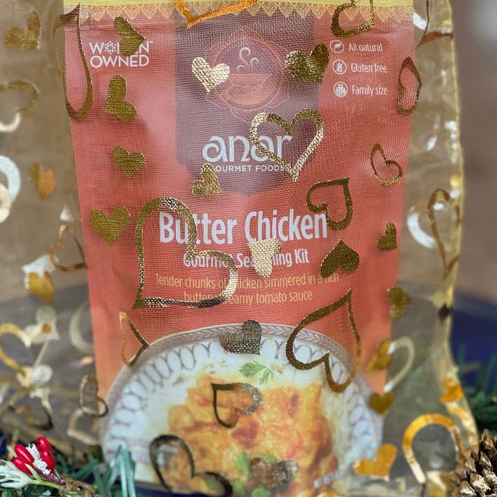 Anar Gourmet Foods golden organza bag with heart pattern — Butter Chicken seasoning blend packet shown inside