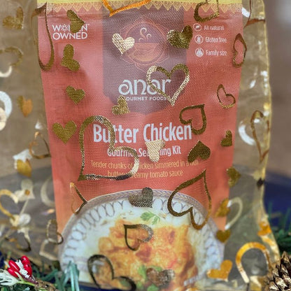 Anar Gourmet Foods golden organza bag with heart pattern — Butter Chicken seasoning blend packet shown inside