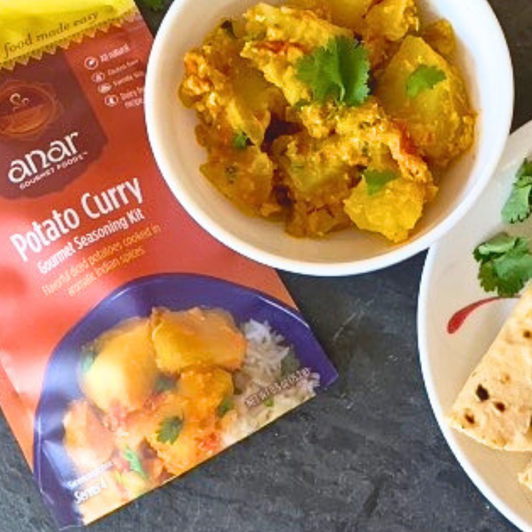 Anar Gourmet Foods all-natural, gluten-free potato curry, served with naan bread and seasoning package