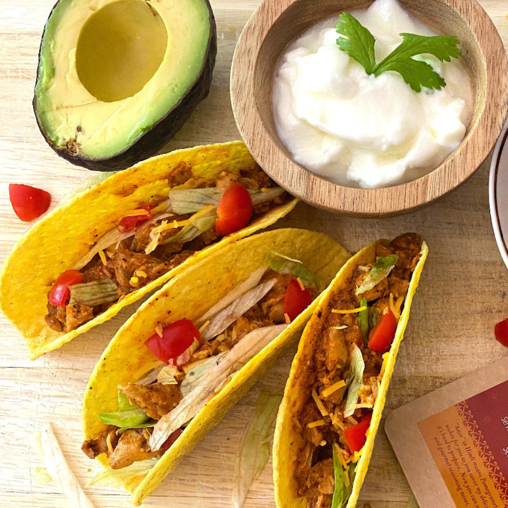 Butter Chicken tacos with avocado and sour cream, made with Anar Gourmet Foods all natural, gluten-free seasoning