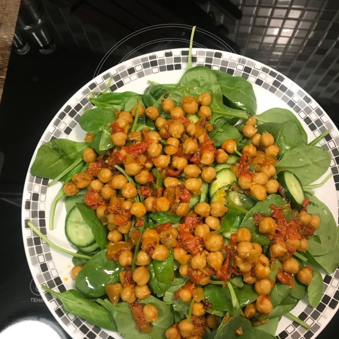 Customer photo of chickpea curry seasoning served over spinach salad with cucumber, made with Anar Gourmet Foods all natural, gluten-free seasoning
