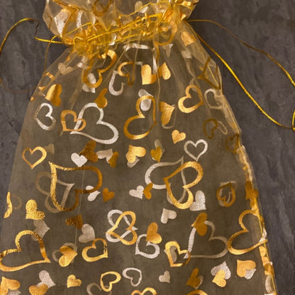 Anar Gourmet Foods gift box — close-up of golden organza bag with heart pattern