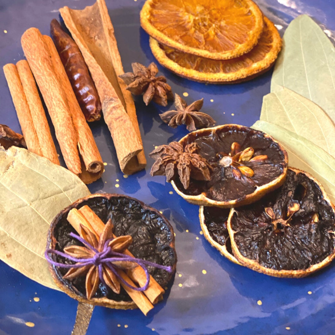 Anar Gourmet Foods Indian seasoning blends gift box — natural decorations including cinnamon sticks, star anise, bay leaves, and dehydrated orange slices