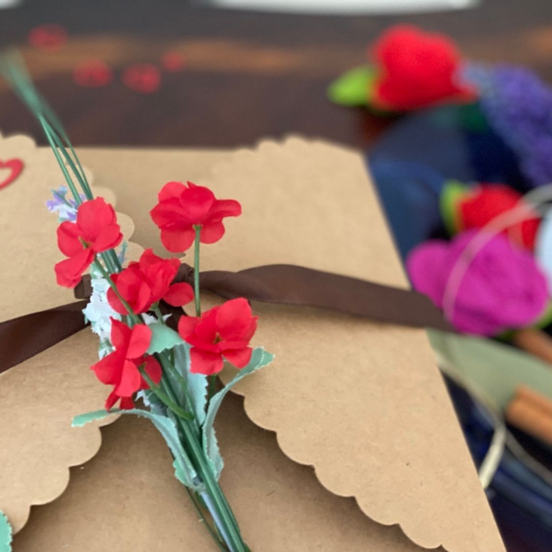 Anar Gourmet Foods Indian seasoning blends gift box — close-up of red floral and ribbon detail on kraft box