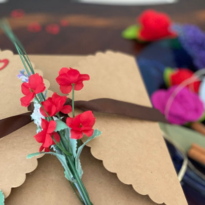 Anar Gourmet Foods Indian seasoning blends gift box — close-up of red floral and ribbon detail on kraft box