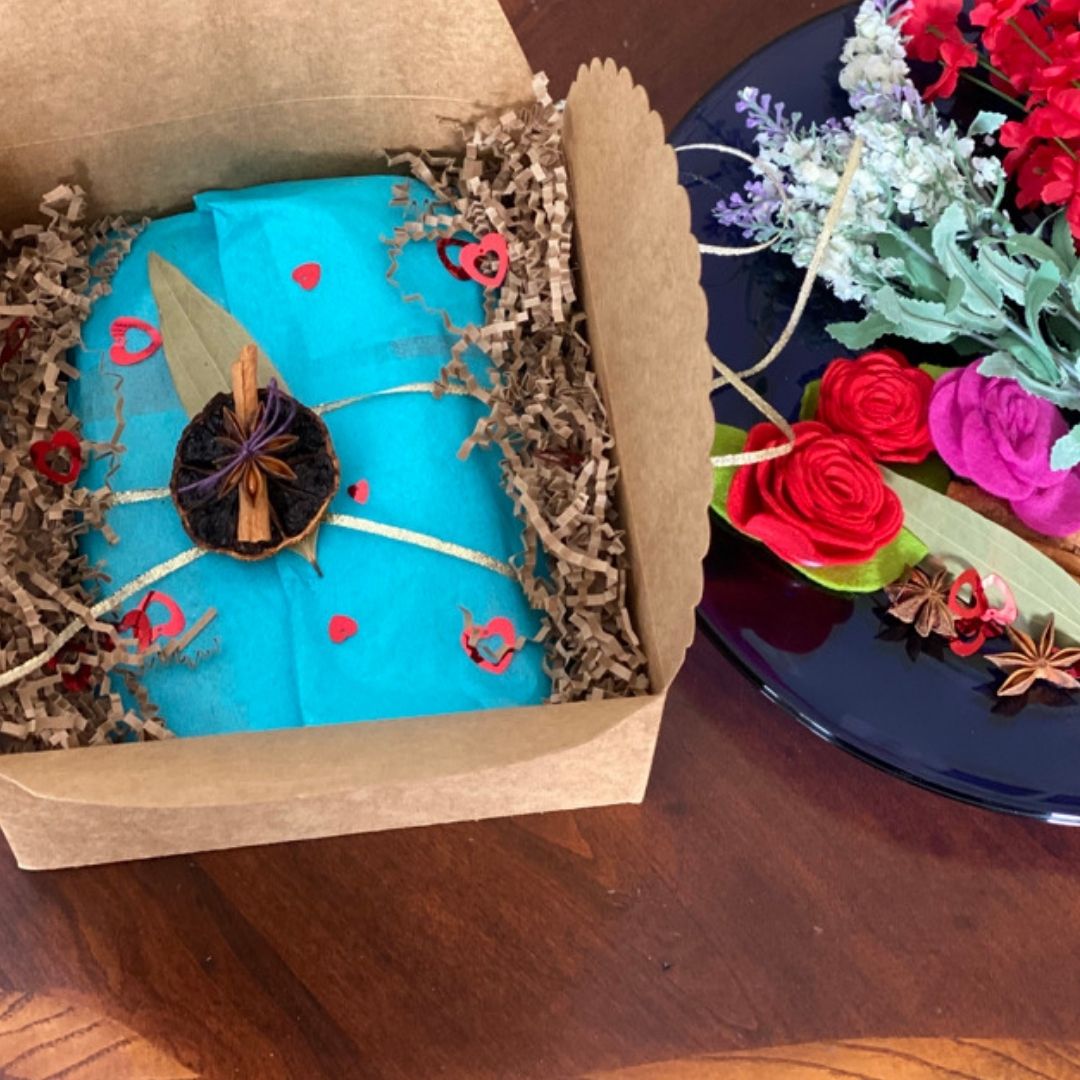 Anar Gourmet Foods Indian seasoning blends gift box with Valentine's Day styling — teal wrapping, heart accents, and rose decorations