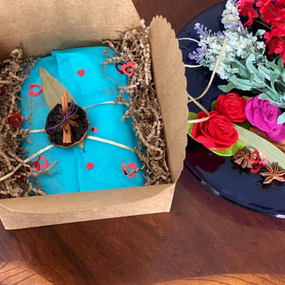 Anar Gourmet Foods Indian seasoning blends gift box with Valentine's Day styling — teal wrapping, heart accents, and rose decorations