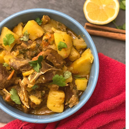 Anar Gourmet Foods all-natural, gluten-free lamb curry seasoning — lamb and potato curry garnished with cilantro