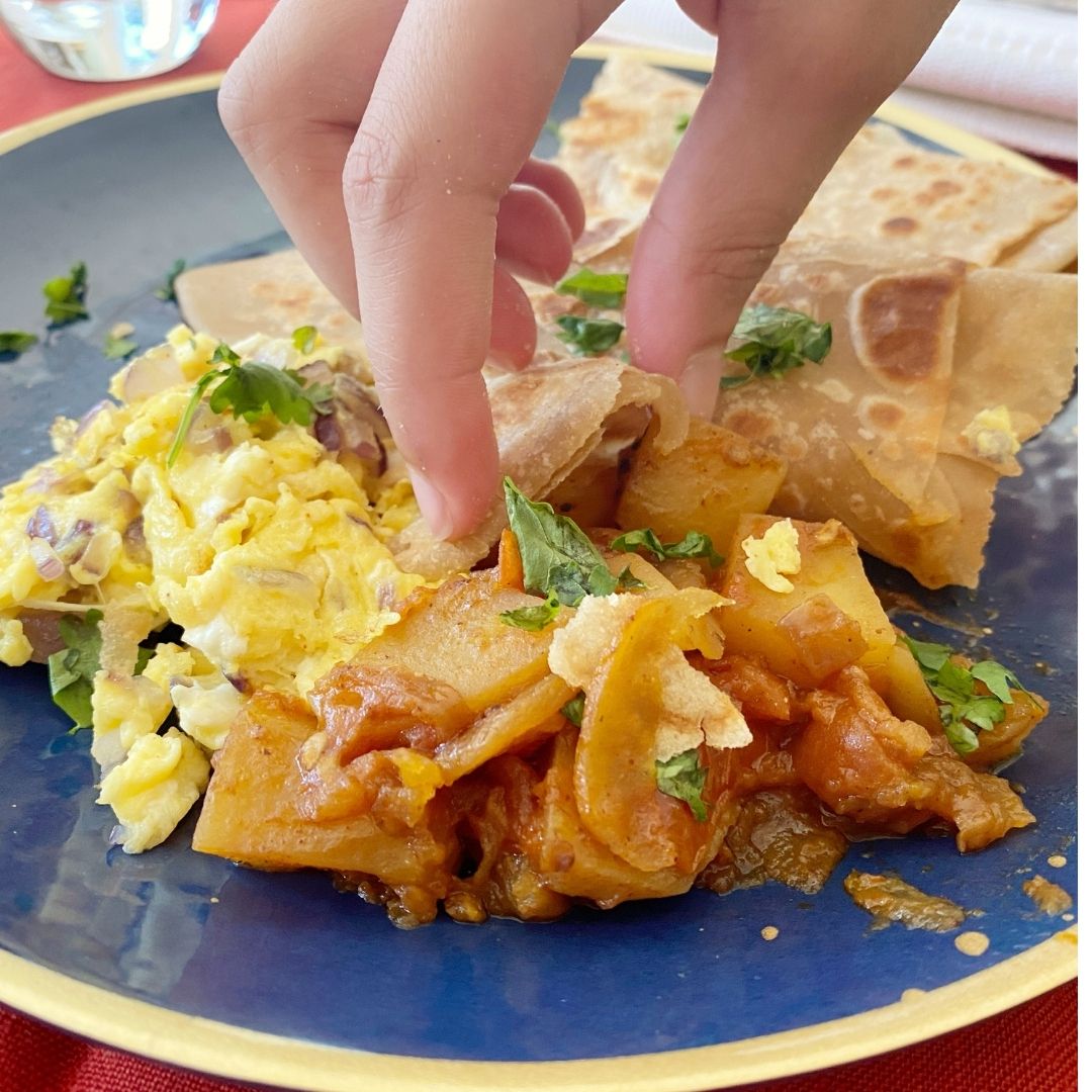 Anar Gourmet Foods all-natural, gluten-free potato curry with scrambled egg topping, served with naan bread