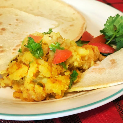 Anar Gourmet Foods all-natural, gluten-free potato curry, wrapped in flatbread with fresh tomato and cilantro