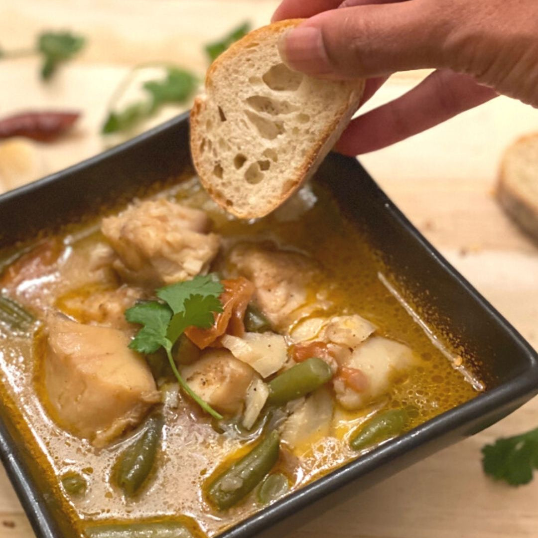 Anar Gourmet Foods all-natural, gluten-free seafood curry with fish and green beans, bread dipped in coconut curry broth