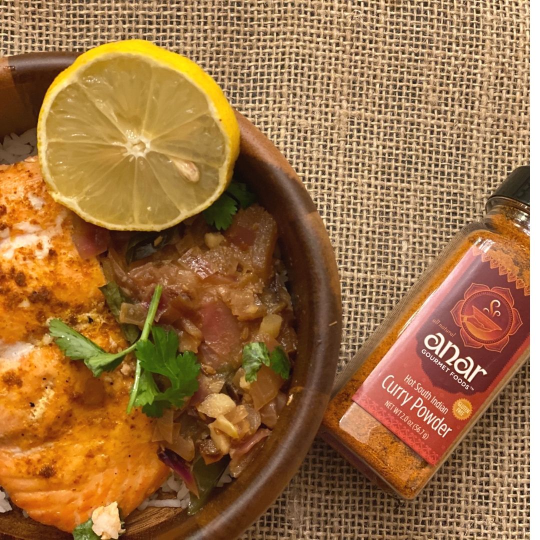 Anar Gourmet Foods all-natural South Indian hot curry powder — with salmon curry , lemon, and cilantro, bottle shown alongside