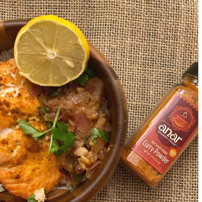 Anar Gourmet Foods all-natural South Indian hot curry powder — with salmon curry , lemon, and cilantro, bottle shown alongside