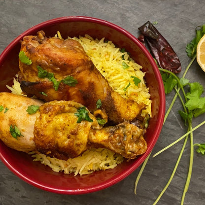 Anar Gourmet Foods all-natural, gluten-free spicy baked chicken, plated over lemon rice and garnished with cilantro