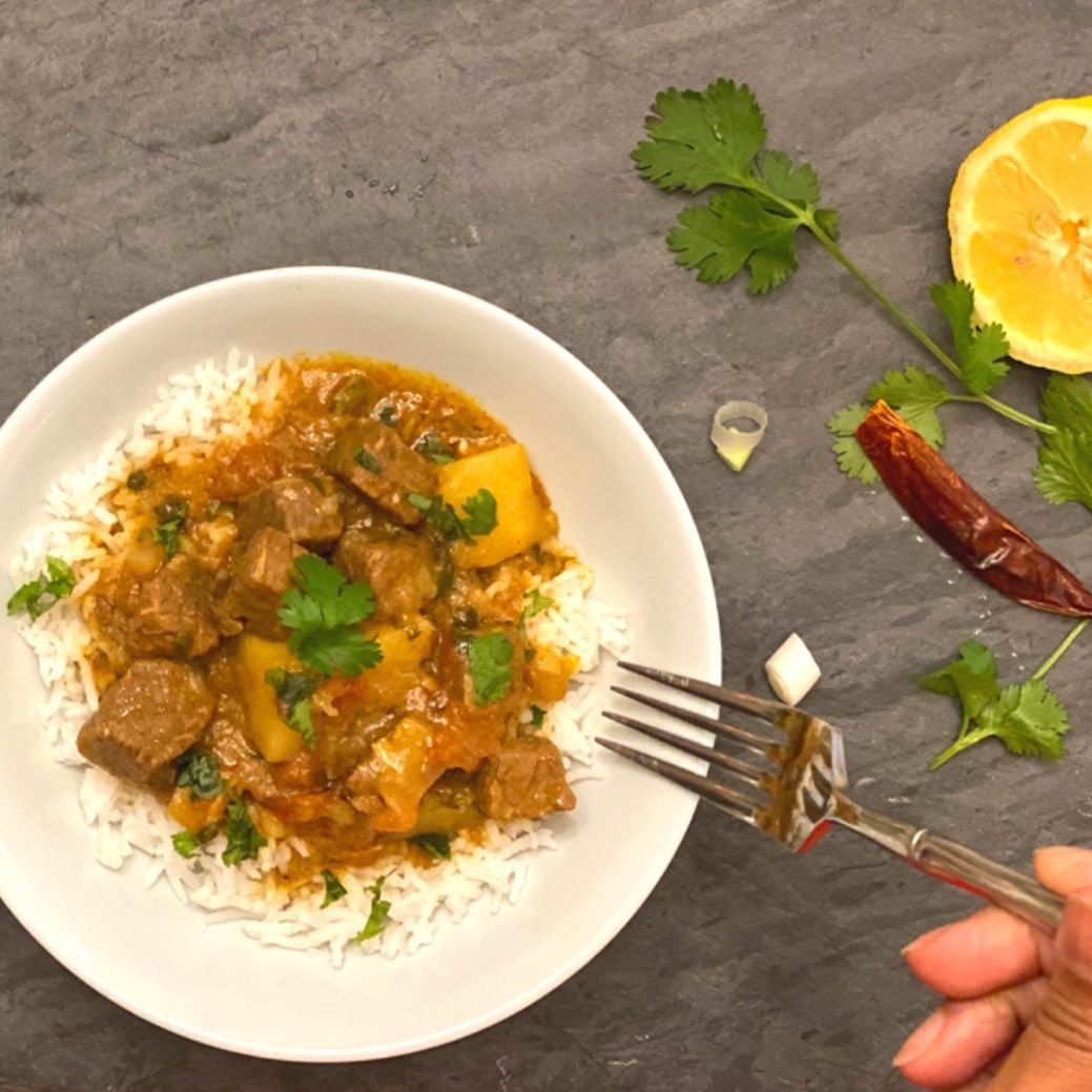Anar Gourmet Foods all-natural, gluten-free spicy beef curry with potatoes, served over rice with lemon